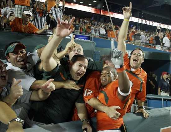 Brandon Harris celebrates with fans after Miami's win.