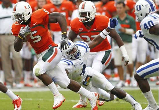 Miami running back Mike James (5) runs past Duke safety Walt Canty (4). (AP Photo/Lynne Sladky)
