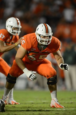 University of Miami Hurricanes offensive lineman Brandon Linder #65 gets set to block in a game against the Virginia Tech Hokies at Sun Life Stadium...