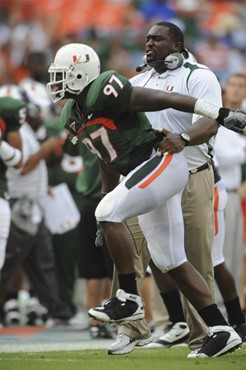 University of Miami Hurricanes defensive lineman Adewale Ojomo #97 celebrates with defensive line coach Clint Hurtt after sacking Wake Forest...