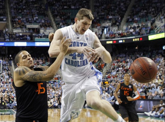 North Carolina's Tyler Zeller (44) is fouled by Miami's Julian Gamble (45) in the first half of an NCAA college basketball game at the Atlantic Coast...