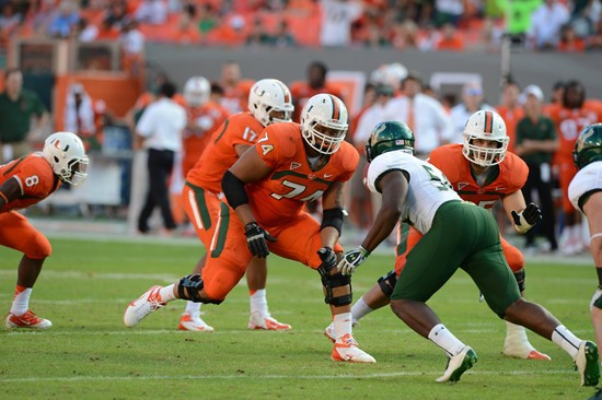 University of Miami Hurricanes offensive lineman Ereck Flowers #74 gets set to block against the University of South Florida Bulls at Sun Life Stadium...