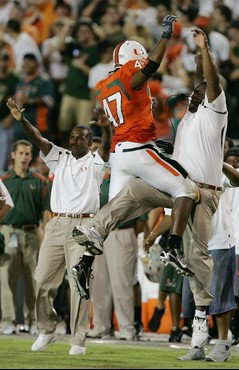 Defensive lineman Vegas Franklin celebrates with a coach after sacking Texas A&M quarterback Stephen McGee during the second quarter. (AP Photo/Luis...