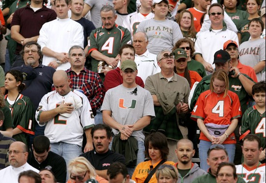 University of Miami fans bow their heads during a moment of silence before the start of the Maryland Miami football game for Hurricane's player Bryan...