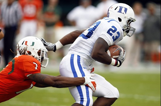 Duke running back Juwan Thompson (23) is brought down by Miami defensive back Vaughn Telemaque (7). (AP Photo/Lynne Sladky)