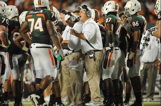 University of Miami Hurricanes  coach  discusses a play with #74 offensive lineman Orlando Franklin on the sidelines in a game against the Florida A&M...