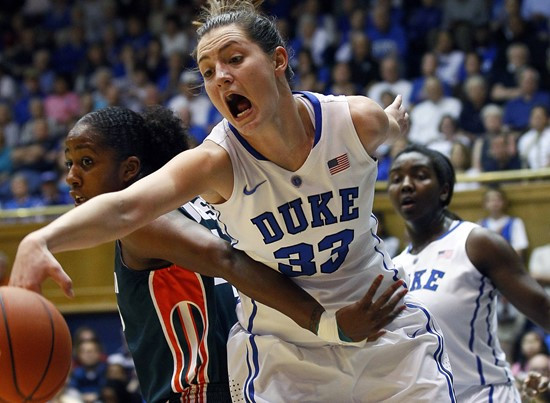 Duke's Haley Peters (33) reaches for the ball as Miami's Shenise Johnson, left, defends during the first half. (AP Photo/Gerry Broome)