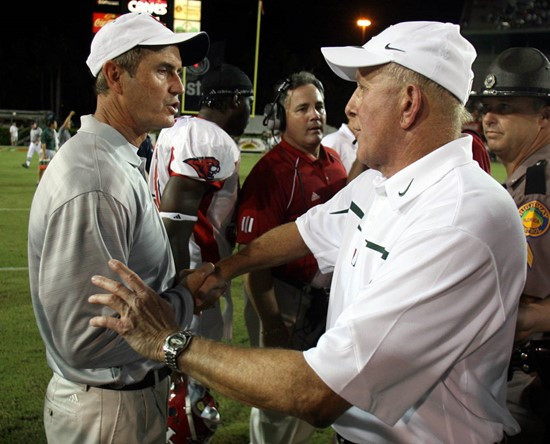 Houston coach Art Briles shakes hands with Miami coach Larry Coker following the game. (AP Photo/Luis M. Alvarez)