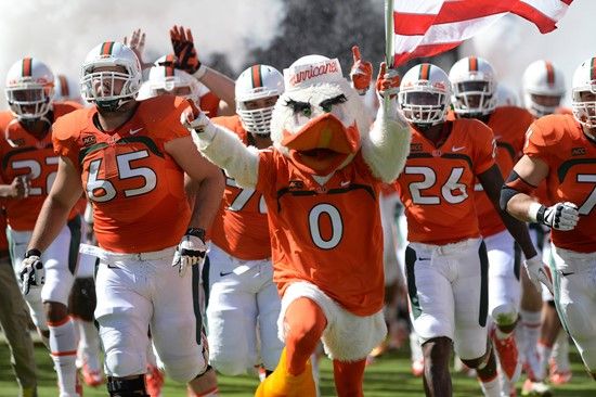 Sebastian the Ibis leads the University of Miami Hurricanes through a tunnel of smoke in a game against the Georgia Tech Yellow Jackets at Sun Life...