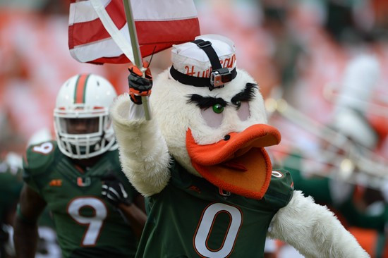 Sebastian the Ibis leads the University of Miami Hurricanes through a tunnel of smoke in a game against the Arkansas State Red Wolves at Sun Life...