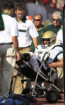 Georgia Tech offensive linesman Jay Finch is wheeled off the field after an injury during the first half against Miami. (AP Photo/Wilfredo Lee)