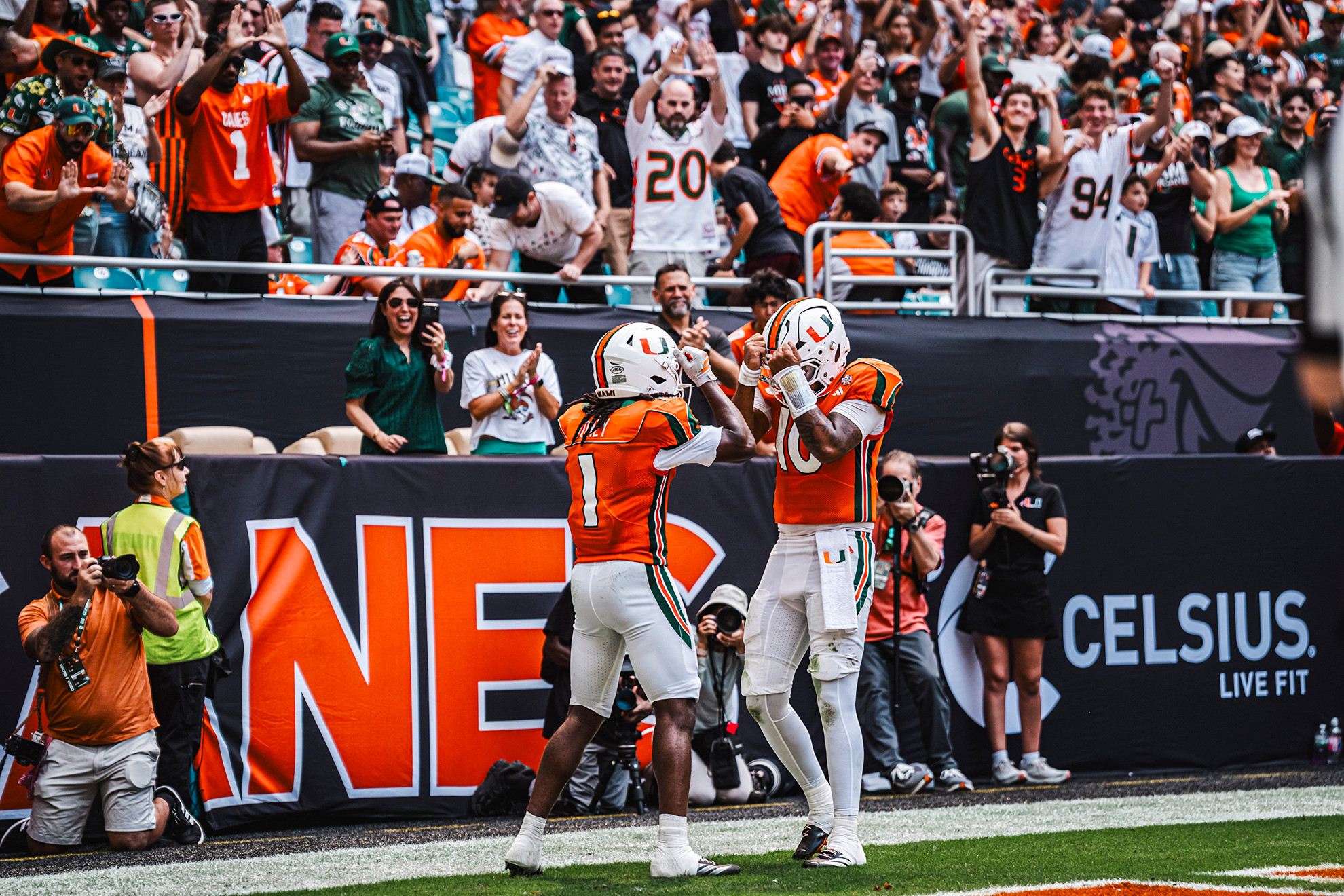 Miami quarterback Darian Mensah and wide receiver Malachi Toney celebrate a touchdown against Pittsburgh.