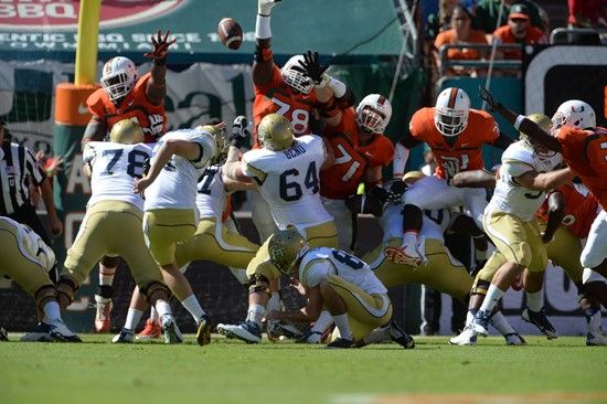 University of Miami Hurricanes defensive lineman Justin Renfrow #78 gets set to block against the Georgia Tech Yellow Jackets at Sun Life Stadium on...