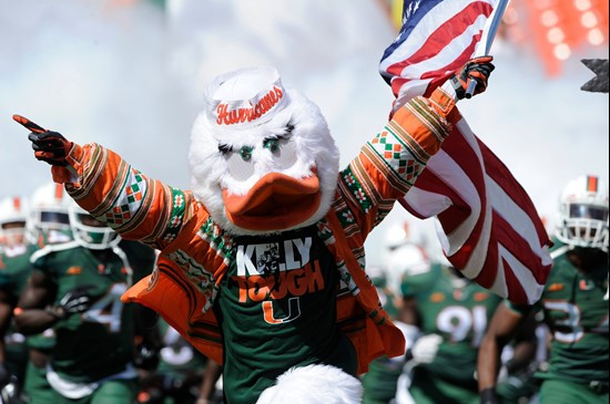 Sebastian the Ibis leads the University of Miami Hurricanes through a tunnel of smoke in a game against the North Carolina Tar Heels at Sun Life...