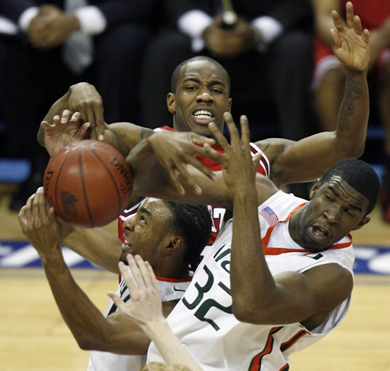 Lance Hurdle, left, and Brian Asbury, right, fight North Carolina State's Gavin Grant for a rebound in the first half. (AP Photo/Rick Havner)