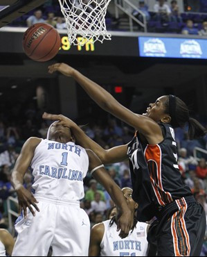 Miami's Sylvia Bullock, right, shoots over North Carolina's She'la White, left, in the first half of an NCAA college basketball game at the Atlantic...