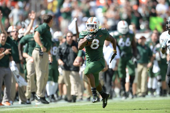 University of Miami Hurricanes running back Duke Johnson #8 scores a touchdown in a game against the North Carolina Tar Heels at Sun Life Stadium on...