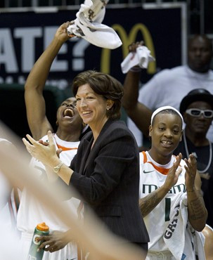 Miami coach Katie Meier, center, along with Sylvia Bullock, left, and Riquna Williams (1), celebrates during the second half of an NCAA women's...