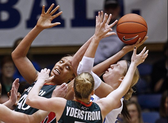 Miami's Shawnice Wilson (40) and Stefanie Yderstrom struggle for a rebound against Duke's Kathleen Scheer during the second half. (AP Photo/Gerry...