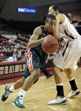 Miami's Riquna Williams (1) pushes past Boston College's Kat Cooper, right. (AP Photo/Gretchen Ertl)