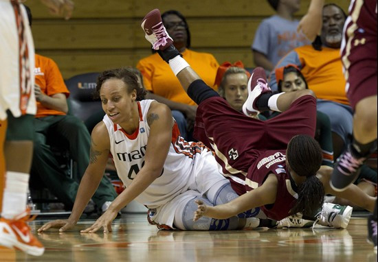 Miami's Shawnice Johnson (40) and Boston College's Tessah Holt (3) fall to the floor after battling for the ball during the second half of an NCAA...