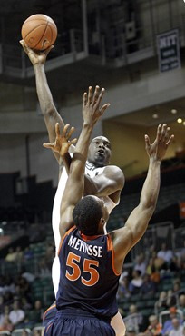 Miami's Dwayne Collins shoots over Virginia's Jerome Meyinsse, (55), during an NCAA college basketball game on Tuesday, Feb. 23, 2010 in Coral Gables,...