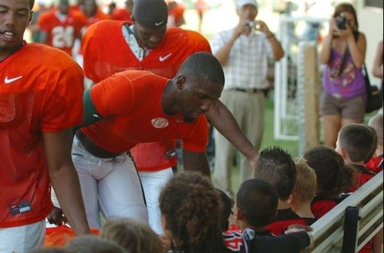 University of Miami Quarterback Jacory Harris #12 greats the Kendall Hammocks Warriors Pee Wee football team after they worked out together at...