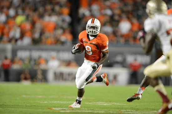 University of Miami Hurricanes running back Duke Johnson #8 catches a deflected pass in a game against the Florida State Seminoles at Sun Life Stadium...