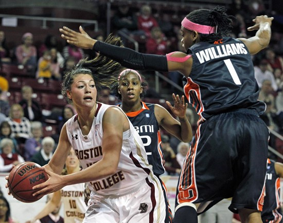 Boston College's Katie Zenevitch, left, looks to pass the ball against the defense of Miami's Riquana Williams (1) and Shenise Johnson, center, during...