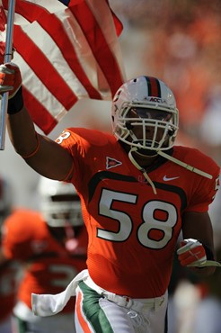 University of Miami Hurricanes linebacker Jordan Futch #58 leads his team through a tunnel of smoke  in a game against the Georgia Tech Yellow Jackets...