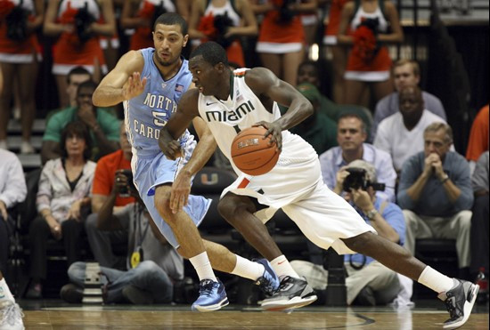 Miami's Durand Scott, right, drives to the basket as North Carolina's Kendall Marshall (5) defends during the first half of an NCAA college basketball...