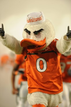 Sebastian the Ibis leads the University of Miami Hurricanes through a tunnel of smoke in a game against the Florida State Seminoles at Sun Life...