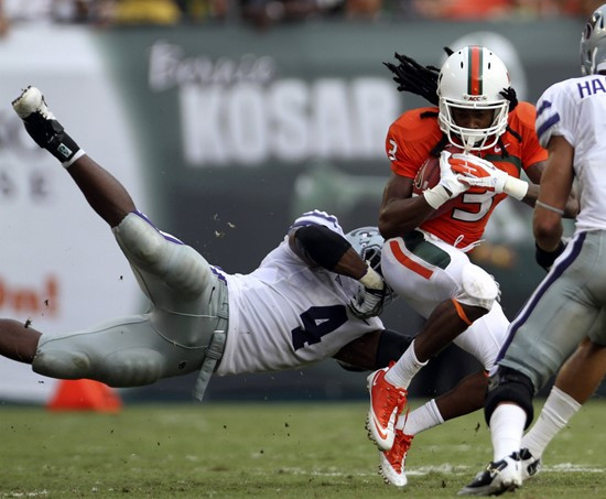 Kansas State's Arthur Brown (4) stops Miami's Travis Benjamin (3) after he made a first down. (AP Photo/J Pat Carter)