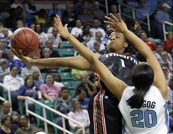 Miami's Riquna Williams (1) shoots over North Carolina's Chay Shegog (20) in the first half of an NCAA college basketball game at the Atlantic Coast...