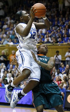 Duke's Chelsea Gray (12) drives to the basket as Miami's Riquna Williams defends during the first half. (AP Photo/Gerry Broome)