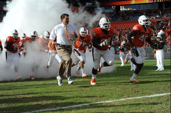University of Miami Hurricanes head coach Al Golden leads his team on the field in a game against the Boston College Eagles at Sun Life Stadium on...