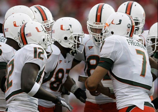 Miami quarterback Kirby Freeman (7) talks to his teammates in a huddle during the first half of their college football game against Maryland Saturday,...