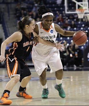 Idaho State's Kaela Oakes, left, tries to tap the ball away from Miami's Michelle Woods in the first half of an NCAA tournament first-round women's...