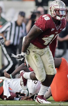 Florida State defensive end Brandon Jenkins (49) celebrates after sacking Miami quarterback Jacory Harris (12) during the second quarter of an NCAA...
