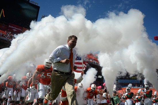 University of Miami Hurricanes head coach Al Golden leads his team on the field in a game against the Georgia Tech Yellow Jackets at Sun Life Stadium...