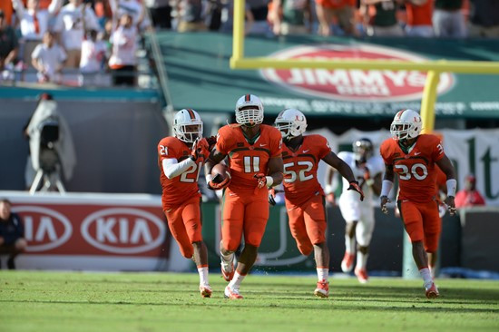 Defensive lineman David Gilbert #11 and The University of Miami Hurricanes plays in a game against the Virginia Cavaliers at Sun Life Stadium on...
