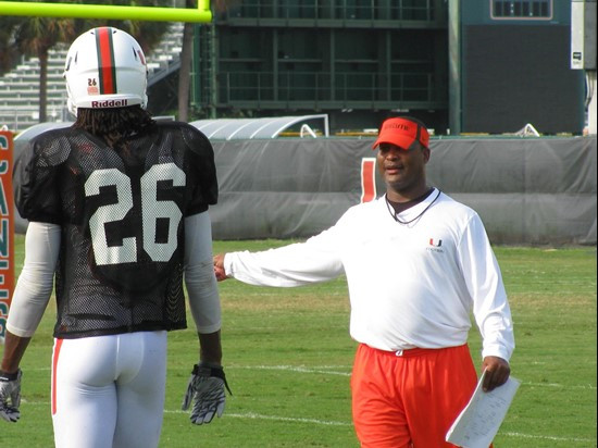 Defensive backs coach Paul Williams instructs safety Ray Ray Armstrong during a team drill on Friday.