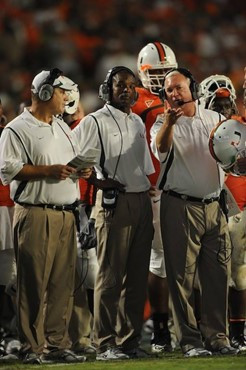 University of Miami Hurricanes head coach Randy Shannon discusses a play with assistant coaches on the sidelines in a game against the Georgia Tech...