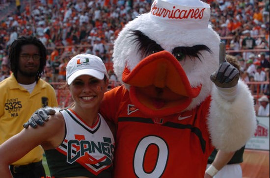 University of Miami mascot Sebastian the Ibis poses for a photo with Sports Illustrated Cheerleader of the Week Lauren Pomponio during a game against...