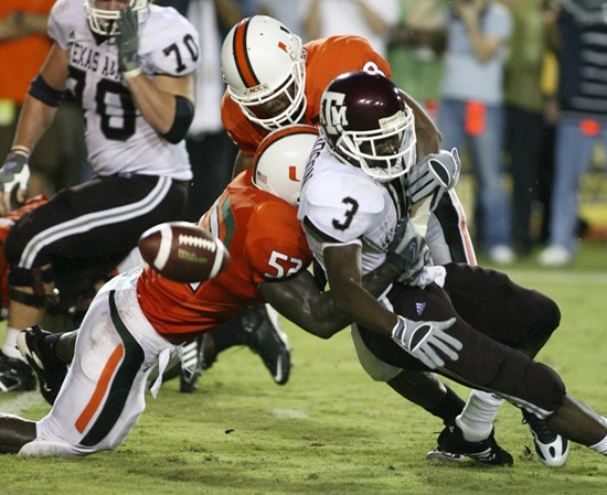 Texas A&M running back Mike Goodson fumbles the ball as he is tackled by Miami linebacker Tavares Gooden during the second quarter. (AP Photo/Luis M....