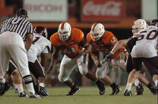 University of Miami offensive lineman Joel Figueroa #61 and Jason Fox #64 get set to block in a game against the Texas A&M Aggies at the Orange Bowl...