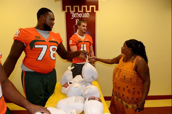 Akil Craig, Justin Renfrow and Ryan Williams handed out turkeys Tuesday afternoon