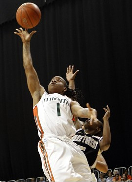 Miami's Riquna Williams (1) shoots over Wake Forest's Chelsea Douglas. (AP Photo/Lynne Sladky)