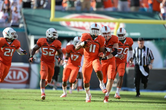Defensive lineman David Gilbert #11 and The University of Miami Hurricanes plays in a game against the Virginia Cavaliers at Sun Life Stadium on...
