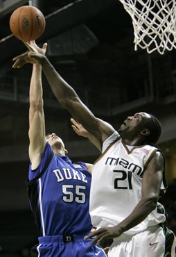 Miami's Dwayne Collins (21) blocks a shot by Duke's Brian Zoubek (55) in the first half of a basketball game in Coral Gables, Fla., Sunday, Jan. 14,...